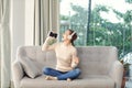 Happy Girl Enjoying Music In headphone And Singing Favourite Song, Relaxing On Sofa Royalty Free Stock Photo