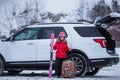 Happy girl enjoying winter sports  cheerful portrait of a girl next to the car and in a ski mask  arrived at the ski resort Royalty Free Stock Photo