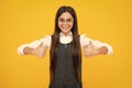 Happy girl face, positive and smiling emotions. Like it. Portrait of joyful teenage child girl showing thumbs up and Royalty Free Stock Photo