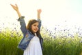 Happy girl on the field of beautiful blue flower of cornflower.