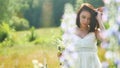 Happy girl in a field with flowers in nature. girl in a field smiling woman holding a bouquet of flowers outdoor Royalty Free Stock Photo
