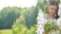 Happy girl in a field with flowers in nature. girl in a field smiling woman holding a outdoor bouquet of flowers Royalty Free Stock Photo