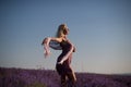 Beautiful girl in a field of lavender on sunset.