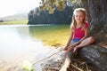 Happy girl fishing at lake Royalty Free Stock Photo