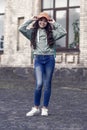 Happy girl fix stylish cap with fashion look wearing casual clothes on urban outdoors, hipster Royalty Free Stock Photo
