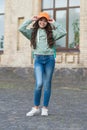 Happy girl fix stylish cap with fashion look wearing casual clothes on urban outdoors, hipster Royalty Free Stock Photo