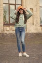Happy girl fix stylish cap with fashion look wearing casual clothes on urban outdoors, hipster Royalty Free Stock Photo