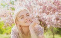 Happy girl with flowers in grass. Cute face of smiling young woman on spring. Dream woman.