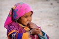 Happy girl with a flowery scarf in the desert.Bedouin village .