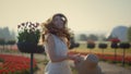 Happy girl with flowing hair jumping in summer garden. Beautiful woman laughing.