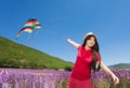 Happy girl flying colorful kite in lavender field Royalty Free Stock Photo
