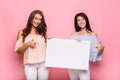 Happy girl friends holding blank advertisement board Royalty Free Stock Photo