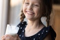 Happy girl with funny moustache drinking milk