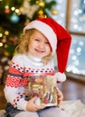 Happy girl with gift box looking at camera Royalty Free Stock Photo