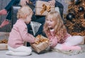 Happy girl gives baby a new year gift Royalty Free Stock Photo