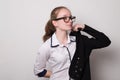 Happy girl in glasses puts on a jacket. Caucasian girl in glasses