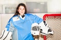 Happy girl goaltender posing after hockey match