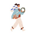 Happy girl going with shopping tote bag, Christmas wreath. Young woman carrying fruits, ornament, preparing for winter Royalty Free Stock Photo