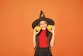 Happy girl on Halloween wear witch carnival costume indoor holding pumpkin, halloween party Royalty Free Stock Photo