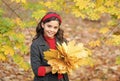 happy girl handful of yellow maple leaves in park, autumn nature