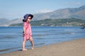 Happy girl in hat and sunglasses, walking near sea Royalty Free Stock Photo