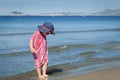 Happy girl in hat and sunglasses, walking near sea Royalty Free Stock Photo