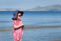 Happy girl in hat and sunglasses, walking near sea Royalty Free Stock Photo