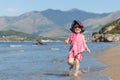 Happy girl in hat and sunglasses, walking near sea Royalty Free Stock Photo