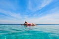 Woman at edge of infinity swimming pool with sea view Royalty Free Stock Photo