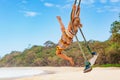 Happy girl have fun swinging high in mid air Royalty Free Stock Photo