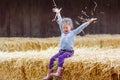 Happy girl having fun with hay on a farm Royalty Free Stock Photo