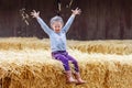 Happy girl having fun with hay on a farm Royalty Free Stock Photo