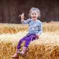 Happy girl having fun with hay on a farm Royalty Free Stock Photo