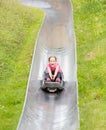 Happy girl having fun at summer bobsled track