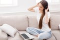 Young women in headphones listening to music and using laptop Royalty Free Stock Photo