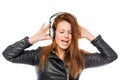 Happy girl with headphones listening to and singing a rock Royalty Free Stock Photo