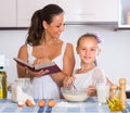 Happy girl helping mother at kitchen Royalty Free Stock Photo
