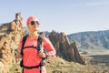 Happy girl hiker reached mountain top, backpacker adventure Royalty Free Stock Photo