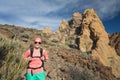 Happy girl hiker walking on mountain path, backpacker adventure