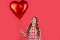 happy girl hold love heart balloon on red background Royalty Free Stock Photo