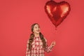 happy girl hold love heart balloon on red background Royalty Free Stock Photo