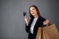 Happy girl hold shopping bag. Shopping with credit card. Smiling girl Royalty Free Stock Photo