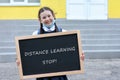 Happy girl holding a chalkboard with the words