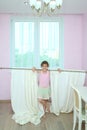 Happy girl holding the curtain with new drapes on Royalty Free Stock Photo