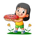 The happy girl is holding the delicious donuts with colorfull messes Royalty Free Stock Photo