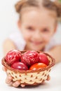 Happy girl holding easter eggs in a basket Royalty Free Stock Photo