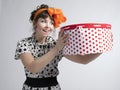 Happy girl holding gift box with red polka dots Royalty Free Stock Photo