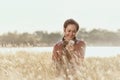 Happy girl holding mobile phones at meadows in the war Royalty Free Stock Photo