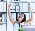 Happy girl holding a poster with the inscription work. The applicant was interviewed and got a job in the office. Royalty Free Stock Photo