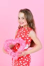 Happy girl holding rosy heart on pink background Royalty Free Stock Photo